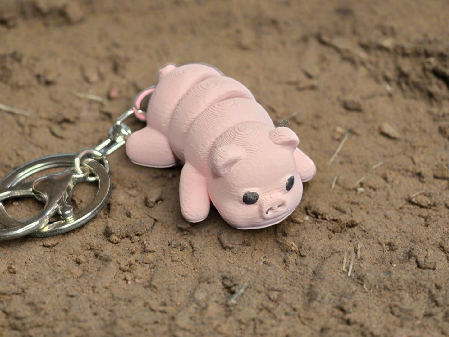 A cute pink piggy keyring. 3D printed by Chaos 3D Printing.