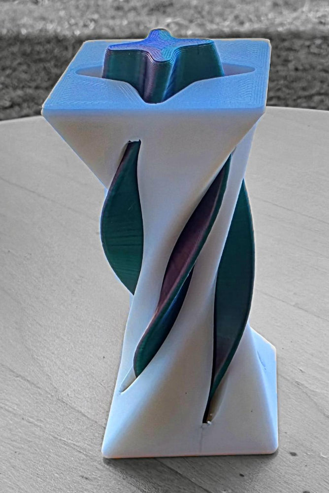 Spiral-shaped object with different colors. Great way to relax with a fidget 3D toy made by Chaos 3D Printing. 